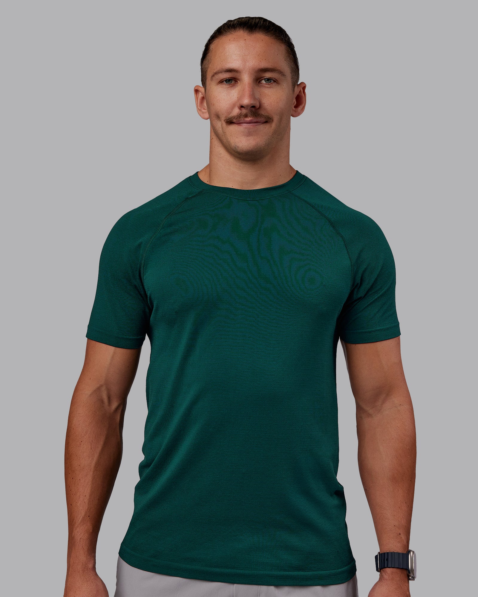 Man wearing AeroFLX+ Seamless Tee - Dark Moss/Dark Moss | Model:Jaiden | Size:M