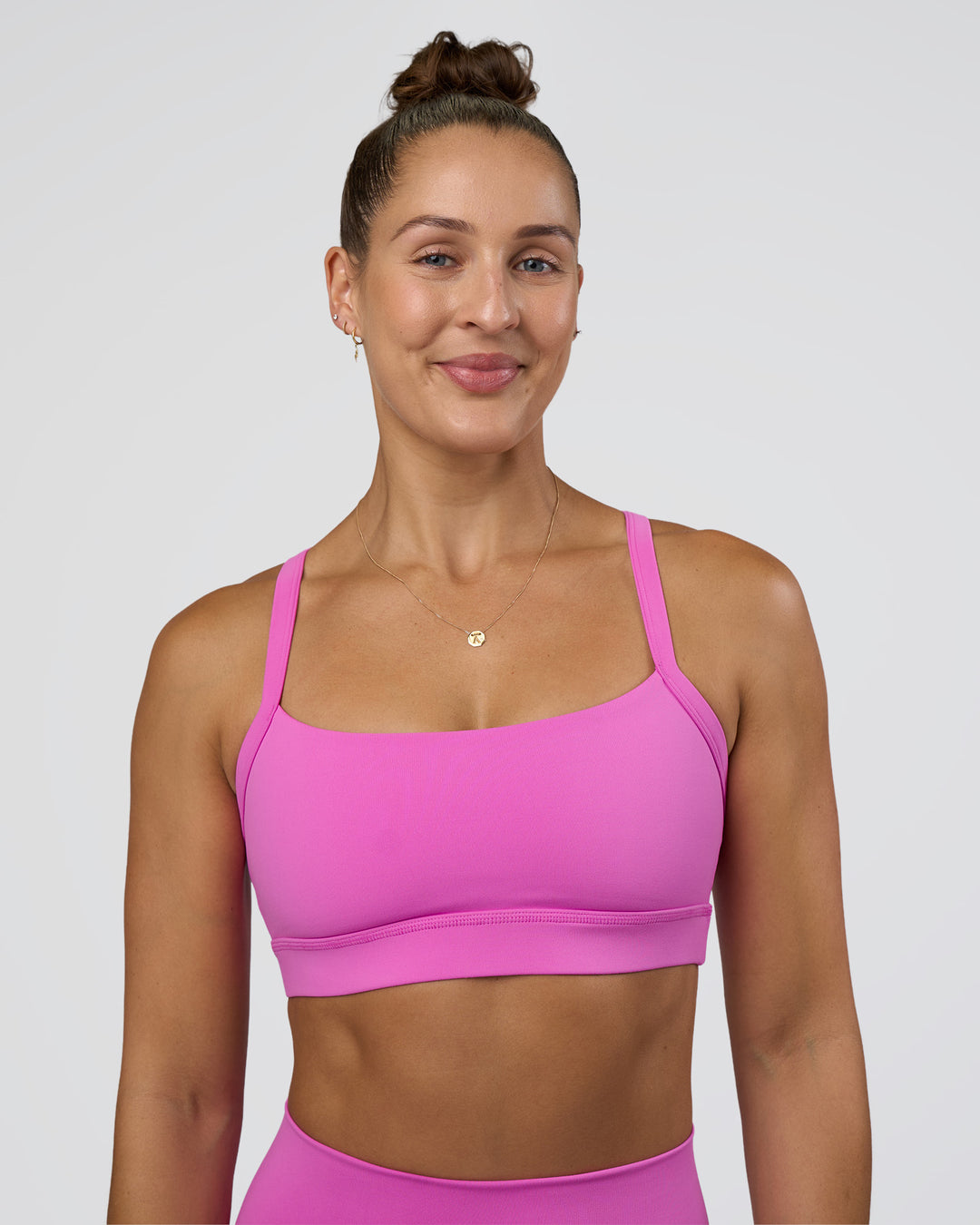 Woman wearing Momentum Sports Bra - Ultra Fuchsia | Model:Abbey | Size:M - view 1