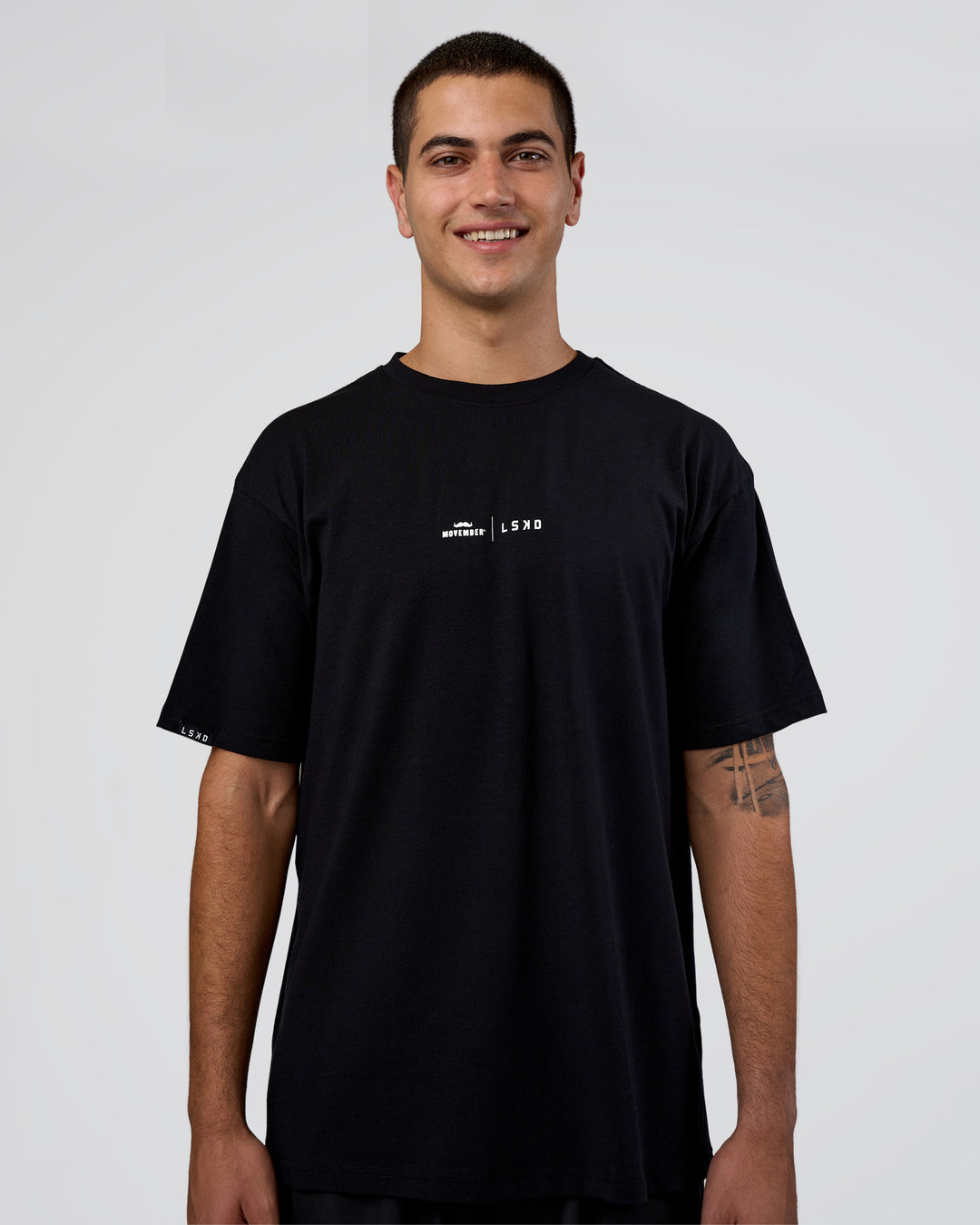 Man wearing Movember 2025 FLXCotton Oversize Tee - Black | Model:Zoran | Size:M - view 3