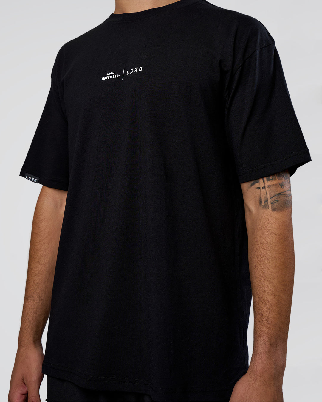 Man wearing Movember 2025 FLXCotton Oversize Tee - Black | Model:Zoran | Size:M - view 9