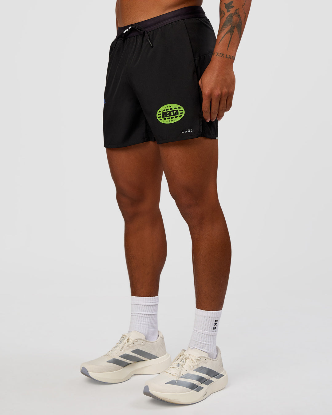 Man wearing Pace 5" Lined Running Short - Black-Lime Glo Indigo | Model:Malebo | Size:M - view 9