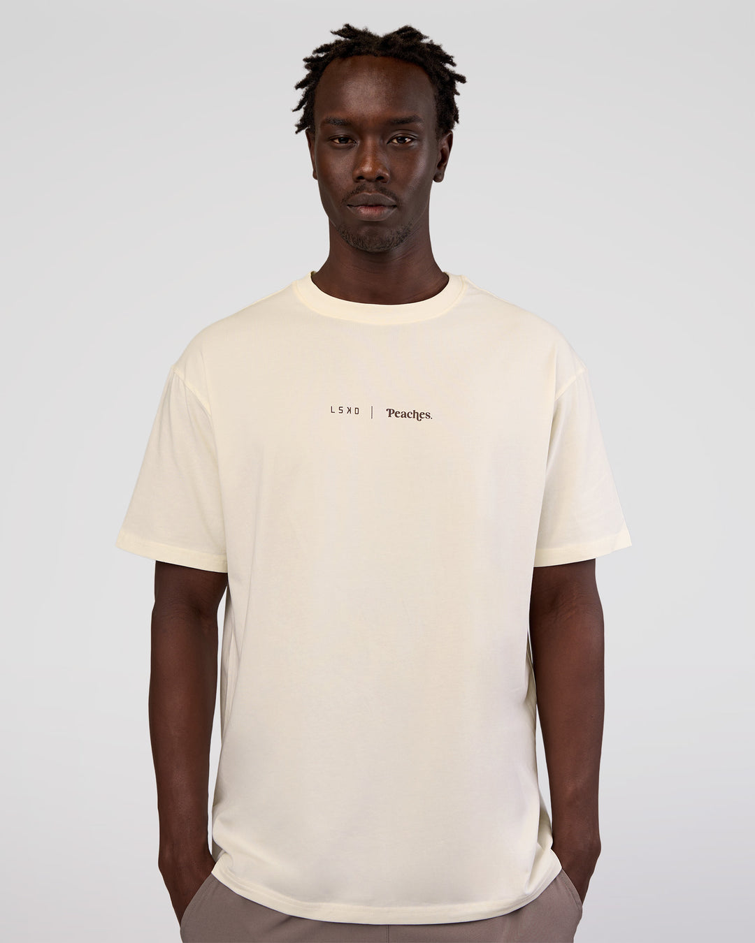 Man wearing Peaches x LSKD Collection FLXCotton Oversize Tee - Off White | Model:Okello | Size:M - view 5