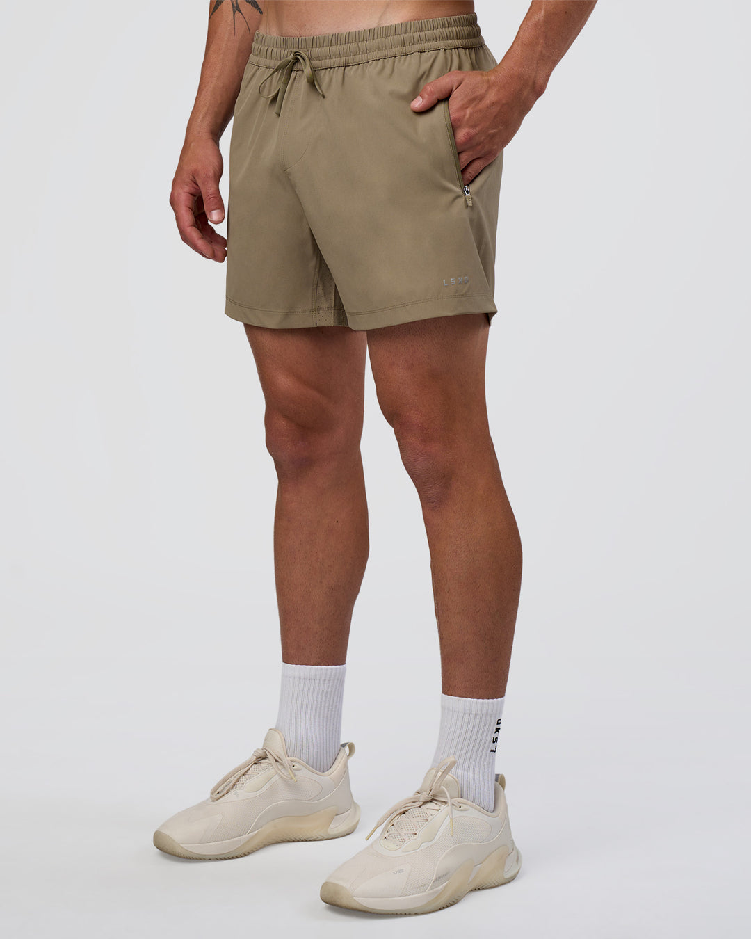 Man wearing Rep 5" Performance Short - Greige | Model:Konnor | Size:M - view 1