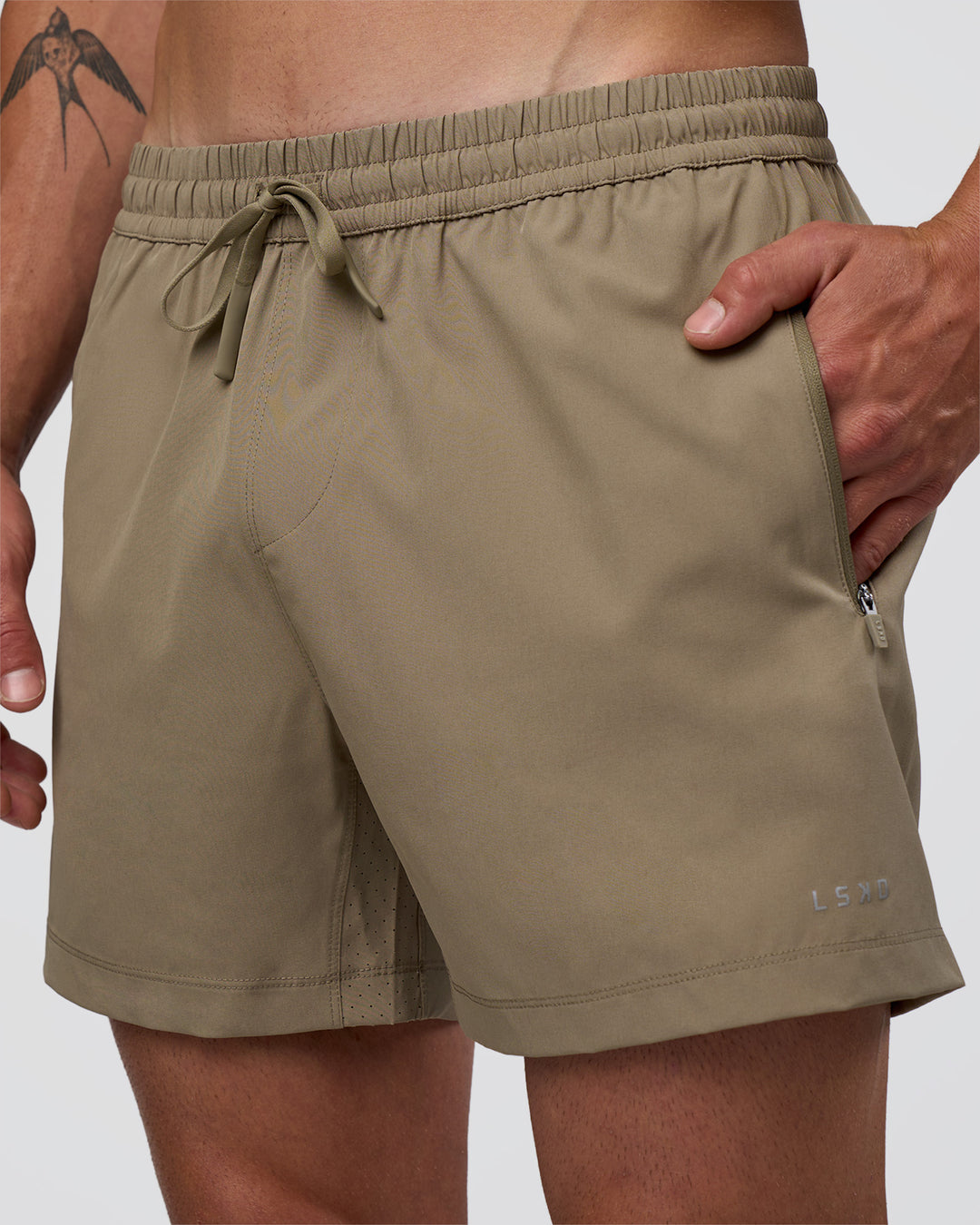 Man wearing Rep 5" Performance Short - Greige | Model:Konnor | Size:M - view 3