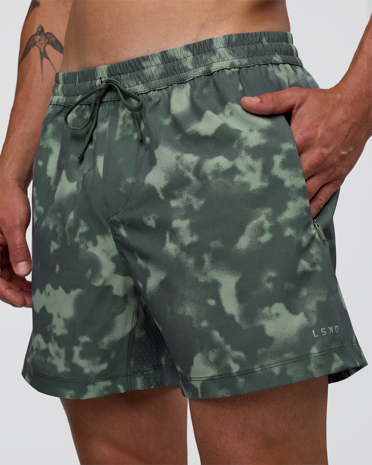 Man wearing Rep 5" Performance Short - Washed Camo Carbon | Model:Konnor | Size:M