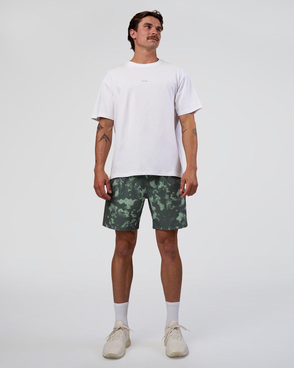 Man wearing Rep 7'' Performance Short - Washed Camo Carbon | Model:Konnor | Size:M