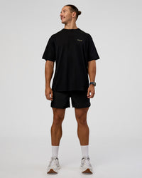 Man wearing RUN CLUB FLXCotton Tee Oversize - Black-Yellow Fizz | Model:Jaiden | Size:M | Thumbnail Index: 6