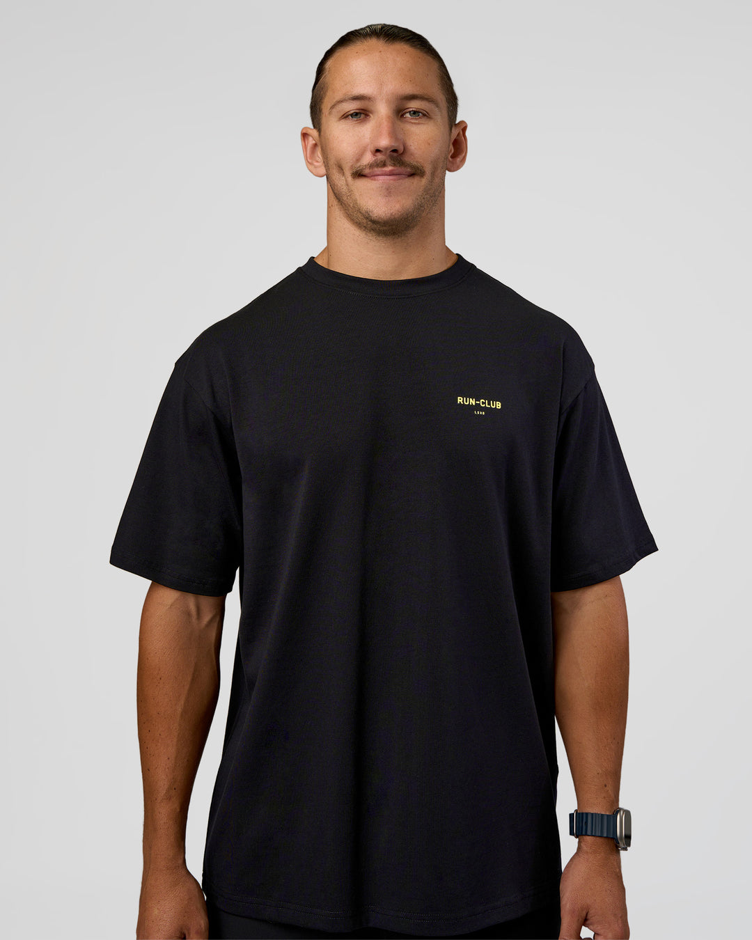 Man wearing RUN CLUB FLXCotton Tee Oversize - Black-Yellow Fizz | Model:Jaiden | Size:M - view 6