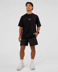 Man wearing Run Club Script FLXCotton Oversized Tee - Black-Palace Blue | Model:George | Size:M | Thumbnail Index: 9