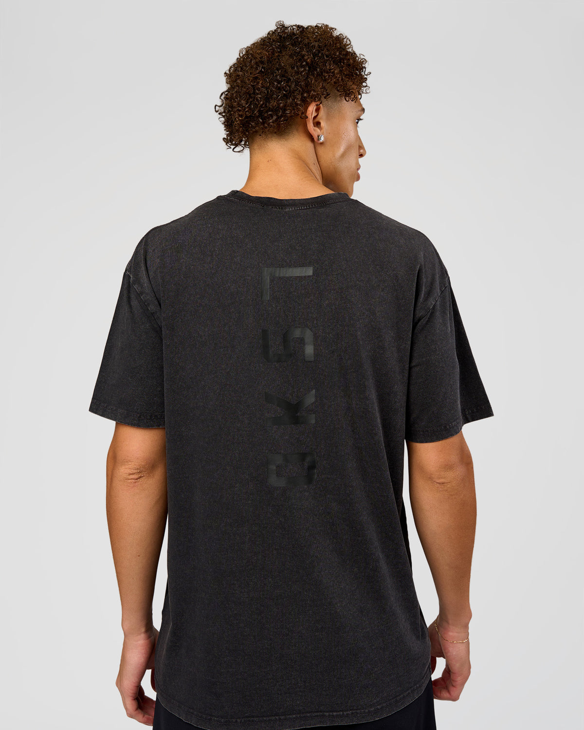 Man wearing Shadow Mode FLXCotton Oversized Tee - Black Washed | Model:Leandro | Size:M