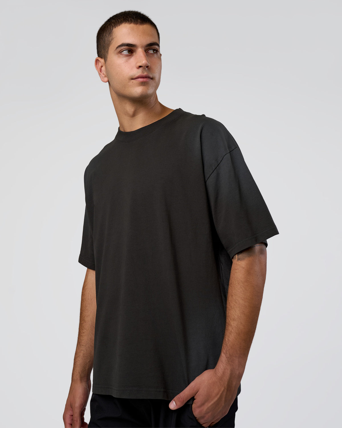 Man wearing Spray Heavyweight Unisex Oversized Tee - Charcoal Washed | Model:Zoran | Size:M