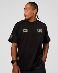 Man wearing Static Grit Heavyweight Oversized Tee - Black-Alloy | Model:Malebo | Size:M | Thumbnail Index: 1