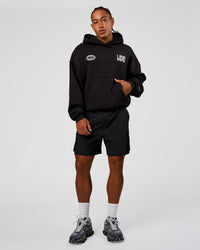 Man wearing Static Grit Unisex Boxy Hoodie - Black-Alloy | Model:Malebo | Size:M | Thumbnail Index: 5
