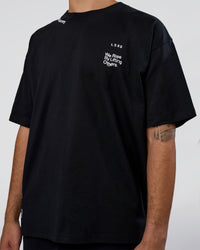 Man wearing Sticker Heavyweight Oversized Tee - Black-White | Model:Zoran | Size:M | Thumbnail Index: 8