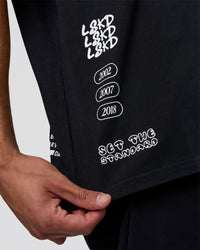 Man wearing Sticker Heavyweight Oversized Tee - Black-White | Model:Zoran | Size:M | Thumbnail Index: 2