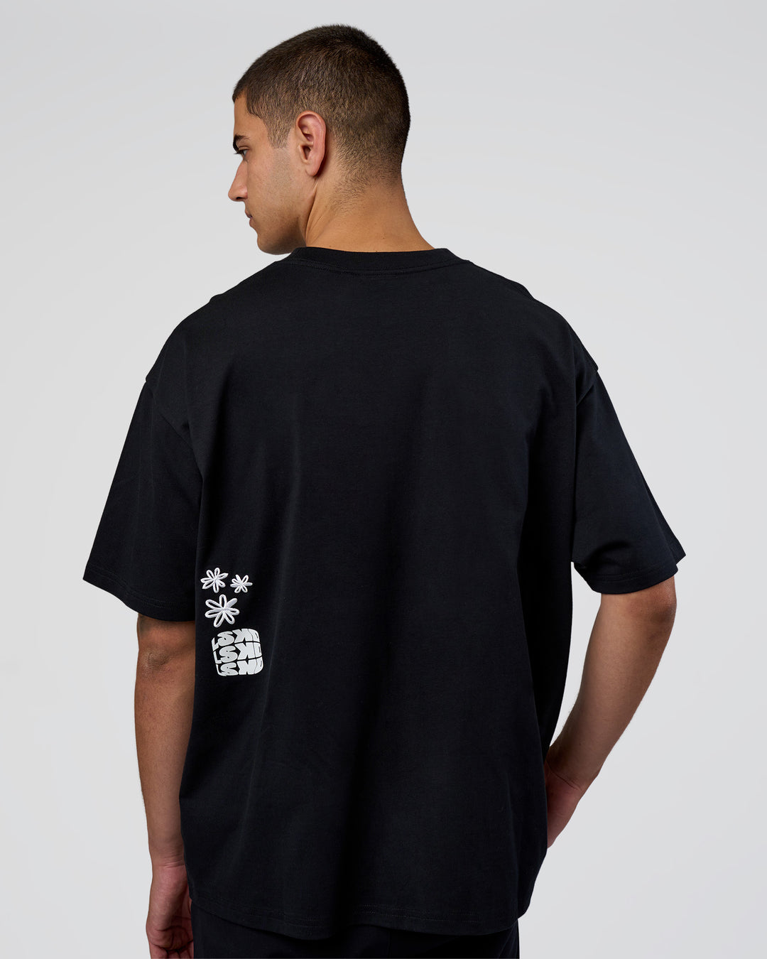 Man wearing Sticker Heavyweight Oversized Tee - Black-White | Model:Zoran | Size:M - view 7