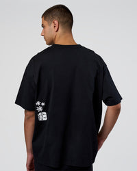 Man wearing Sticker Heavyweight Oversized Tee - Black-White | Model:Zoran | Size:M | Thumbnail Index: 6