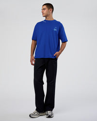 Man wearing Sticker Heavyweight Oversized Tee - Electric Indigo-Baltic Sea | Model:Zoran | Size:M | Thumbnail Index: 6