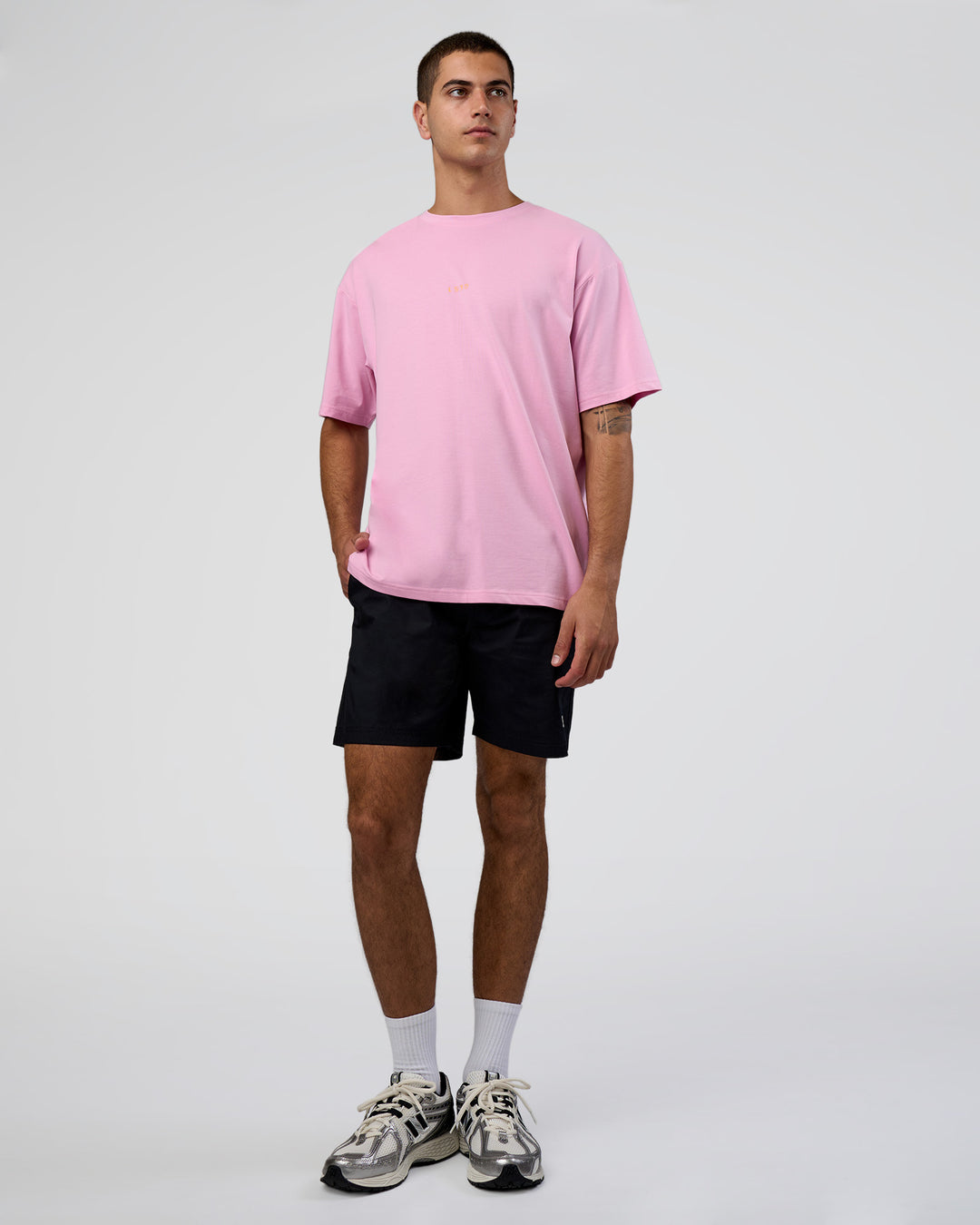 Man wearing Together We Rise FLXCotton Oversized Tee - Bubblegum-Warm Apricot | Model:Zoran | Size:L - view 5