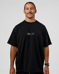 Man wearing Trust The Process Heavyweight Unisex Oversized Tee - Black-White | Model:Jaiden | Size:M | Thumbnail Index: 2