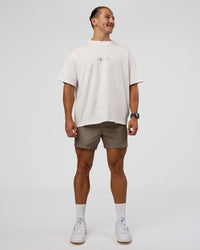 Man wearing Trust The Process Heavyweight Unisex Oversized Tee - Off White-Electric Indigo | Model:Jaiden | Size:M | Thumbnail Index: 5