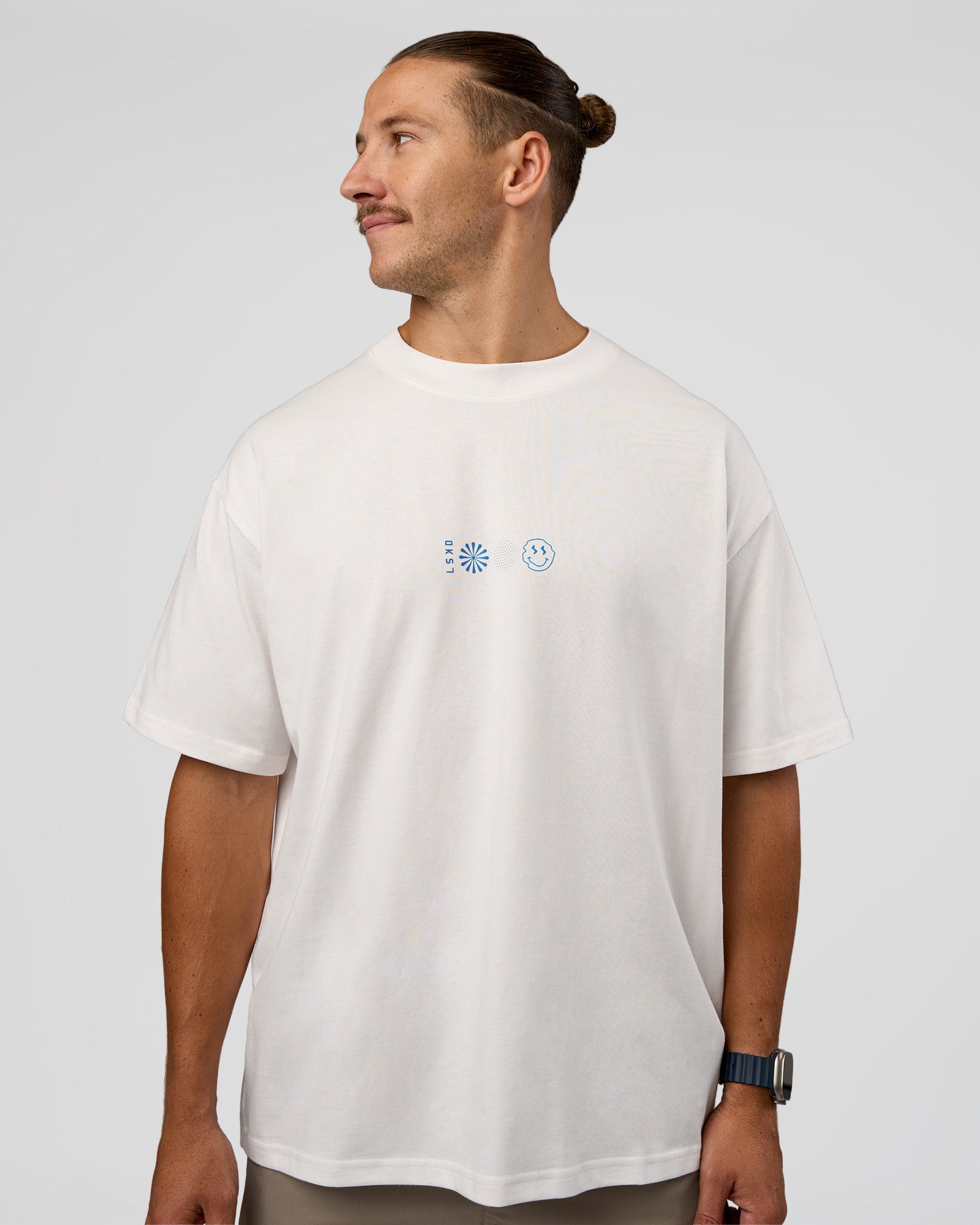 Man wearing Trust The Process Heavyweight Unisex Oversized Tee - Off White-Electric Indigo | Model:Jaiden | Size:M
