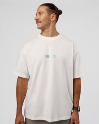 Man wearing Trust The Process Heavyweight Unisex Oversized Tee - Off White-Electric Indigo | Model:Jaiden | Size:M | Thumbnail Index: 1
