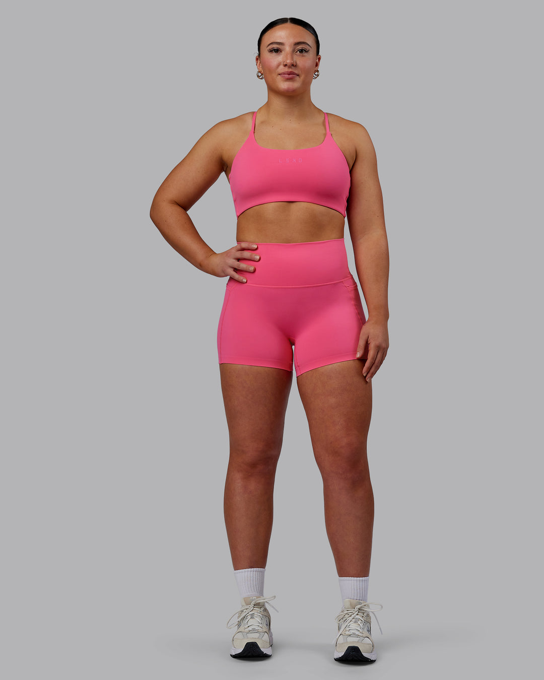 Woman wearing Twist Sports Bra - Carmine Rose - view 6