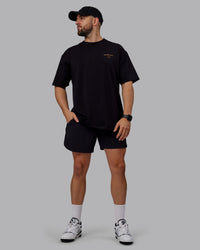 Man wearing Unisex Trust The Process 2.0 FLXCotton Tee Oversize - Black-Vibrant Orange | Thumbnail Index: 4