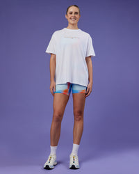 Woman wearing Unity Go-To FLX Cotton Tee - White-Rainbow | Model:Mon | Size:M | Thumbnail Index: 1