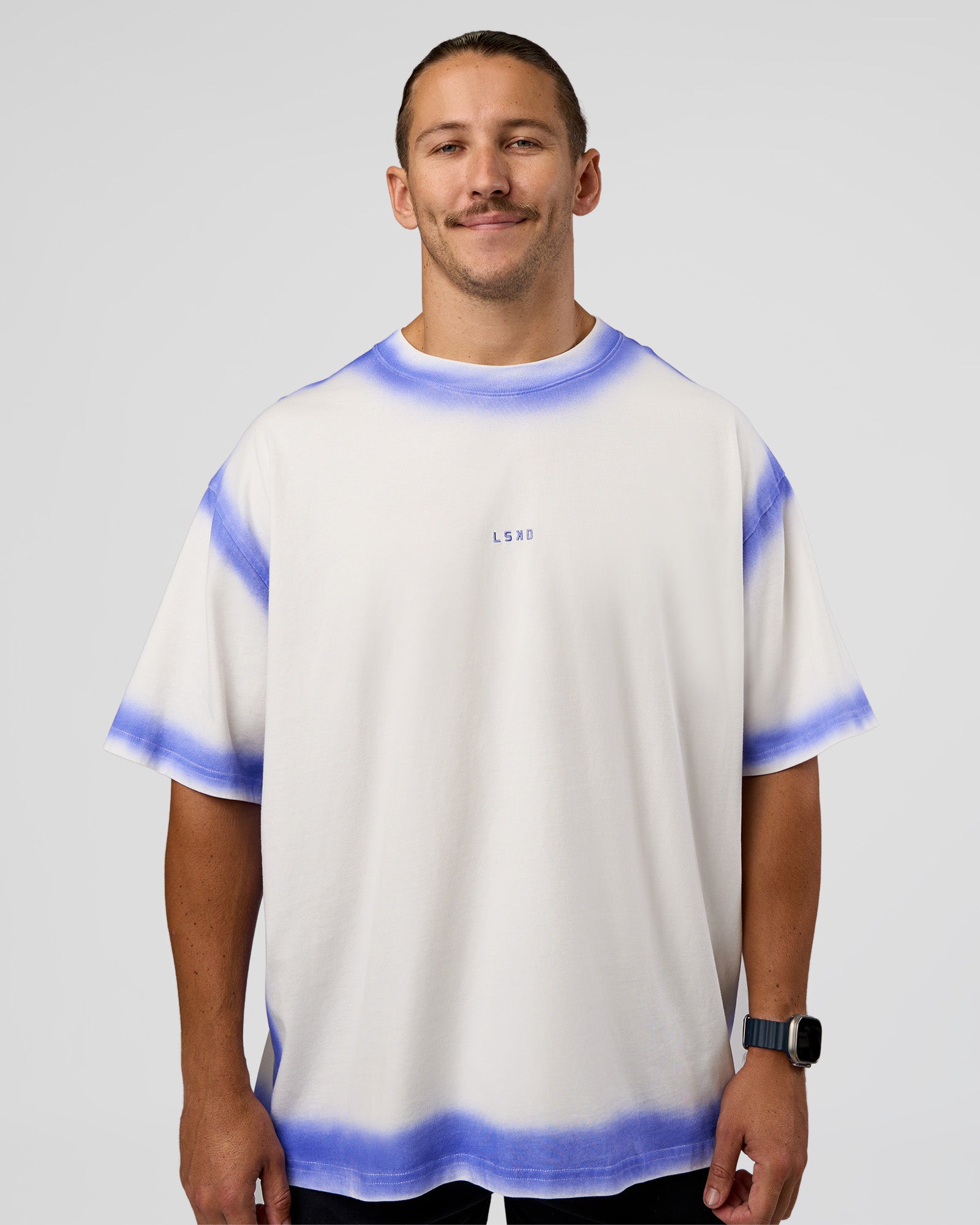 Man wearing Urban Blur Heavyweight Unisex Oversized Tee - Off White-Power Cobalt | Model:Jaiden | Size:M