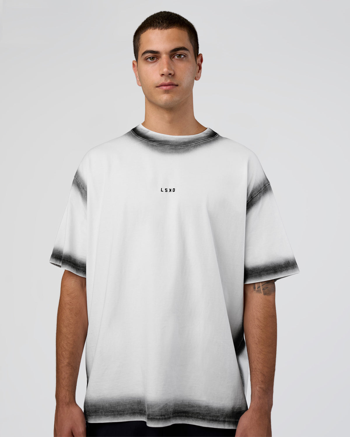 Man wearing Urban Blur Heavyweight Unisex Oversized Tee - White-Black | Model:Zoran | Size:M