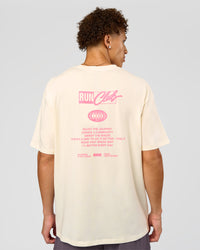 Man wearing Values Run Club FLXCotton Tee - Off White-Candy Pink | Model:Leandro | Size:M | Thumbnail Index: 1