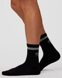 Man wearing Run Club Fast Performance Socks 2.0 - Black-Reflective | Thumbnail Index: 1
