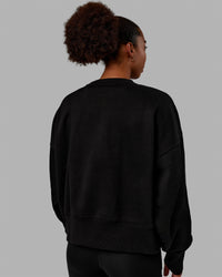 Woman wearing 1% Better Heavyweight Sweater - Black-White | Thumbnail Index: 3