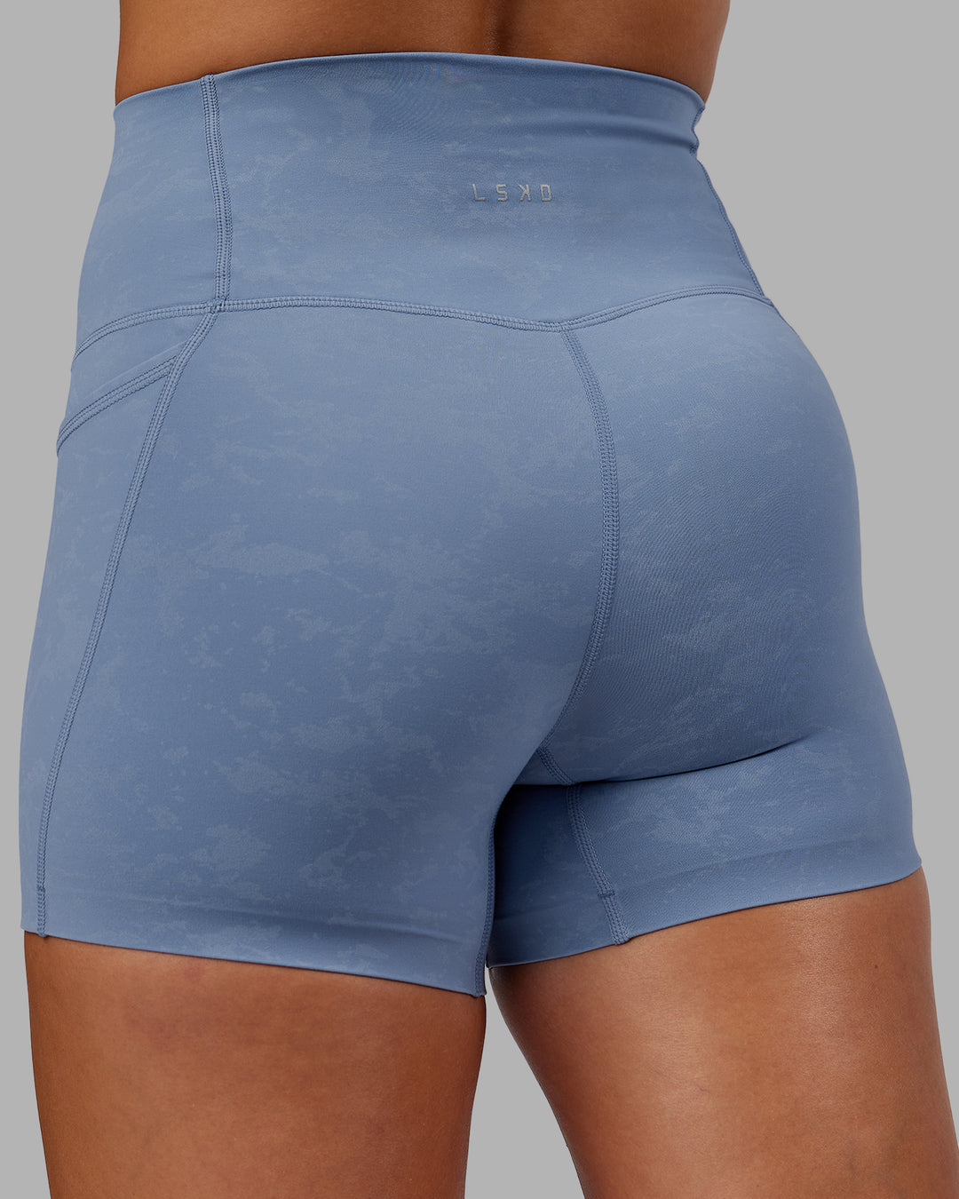 Woman wearing Abs Elixir Ultra High-Rise 4" Short Pockets - Infinity Mirage - view 9
