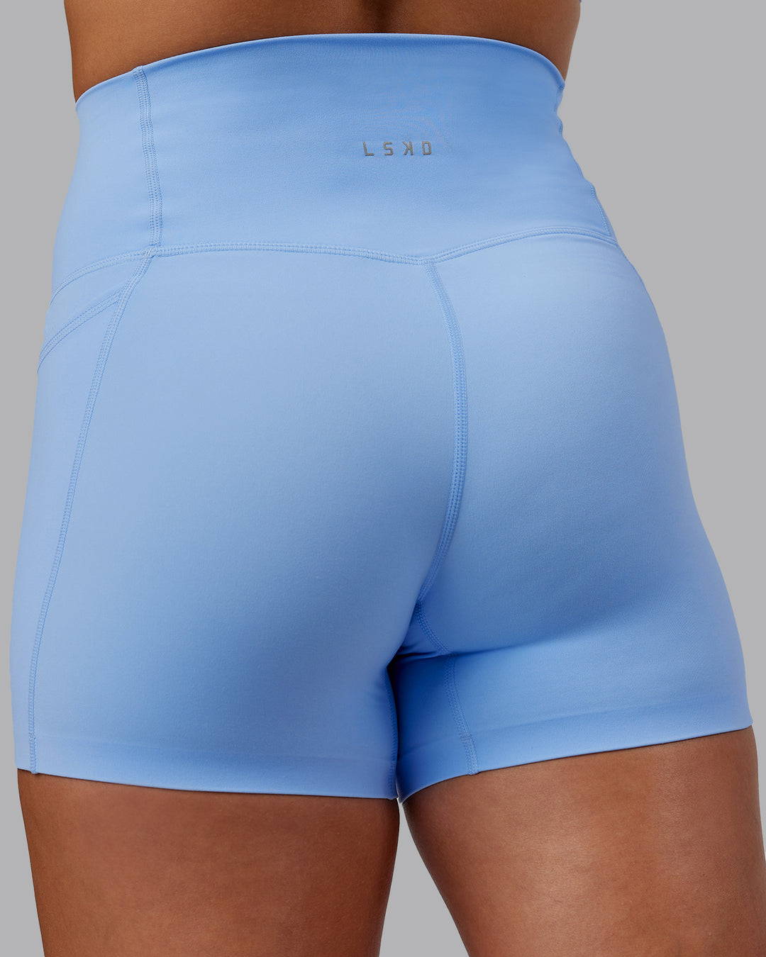 Woman wearing Abs Elixir Ultra High-Rise 4" Short Pockets - Open Air - view 10