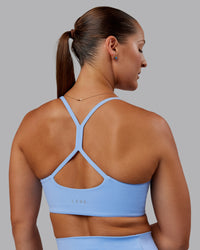 Woman wearing Abs Movement Sports Bra - Open Air | Thumbnail Index: 1