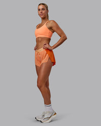 Woman wearing Accelerate 3" Run Shorts - Cantaloupe Colourblock | Thumbnail Index: 5