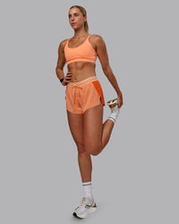 Woman wearing Accelerate 3" Run Shorts - Cantaloupe Colourblock | Thumbnail Index: 7