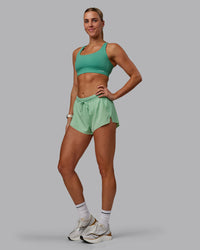 Woman wearing Accelerate 3" Run Shorts - Surreal Green | Thumbnail Index: 4