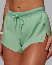Woman wearing Accelerate 3" Run Shorts - Surreal Green | Thumbnail Index: 7