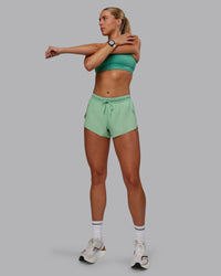 Woman wearing Accelerate 3" Run Shorts - Surreal Green | Thumbnail Index: 0