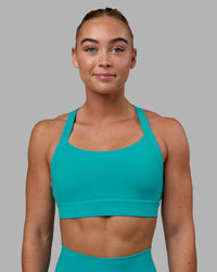 Woman wearing Advance Sports Bra - Uplift Blue | Thumbnail Index: 1