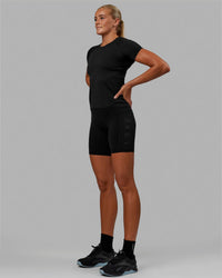 Woman wearing AeroFLX+ Seamless Tee - Black Marl | Thumbnail Index: 2
