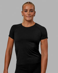 Woman wearing AeroFLX+ Seamless Tee - Black Marl | Thumbnail Index: 0