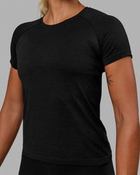 Woman wearing AeroFLX+ Seamless Tee - Black Marl | Thumbnail Index: 5