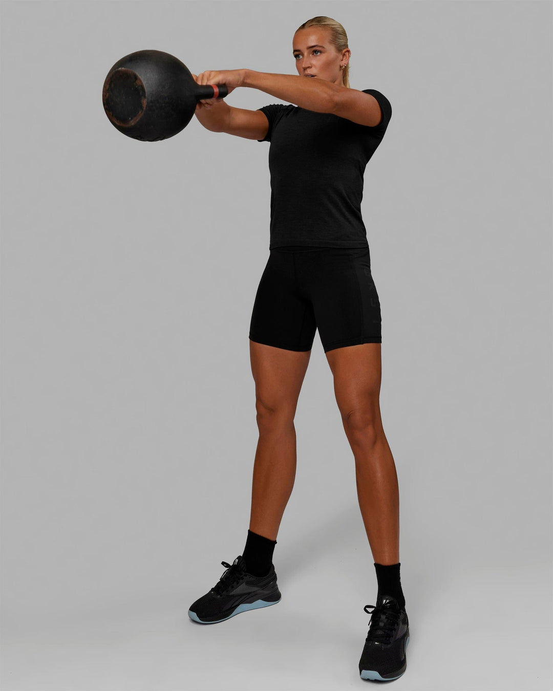 Woman wearing AeroFLX+ Seamless Tee - Black Marl - view 7
