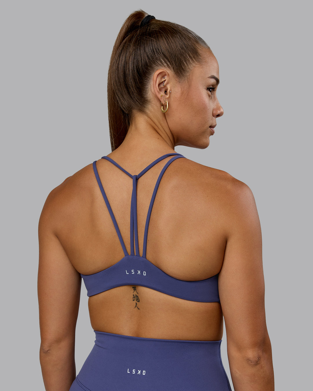 Woman wearing Agile Sports Bra - Future Dusk - view 1