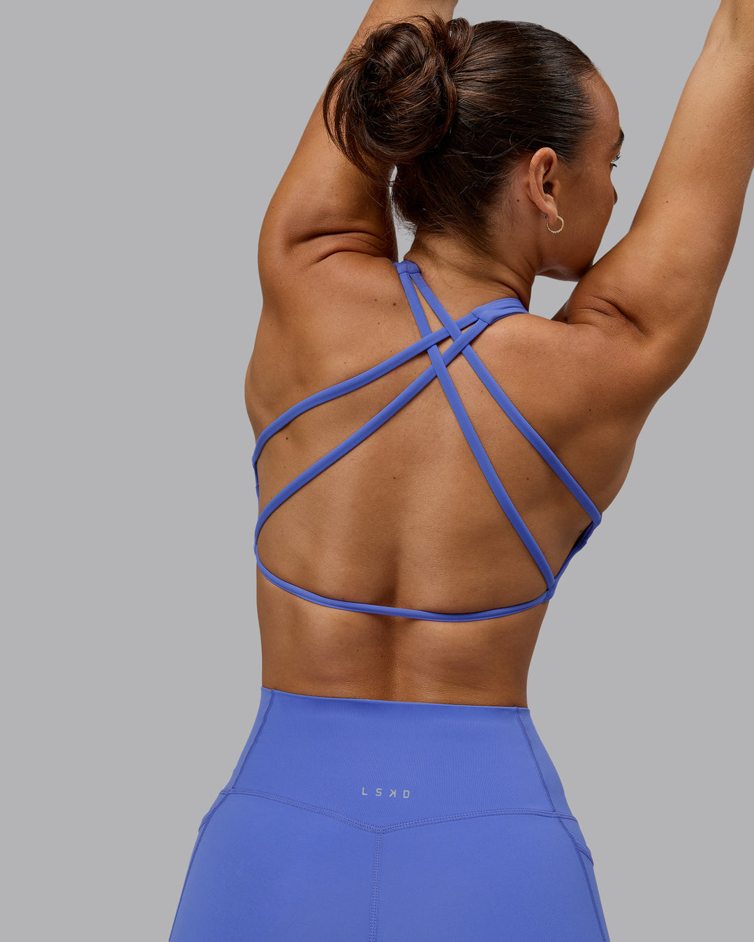 Woman wearing Aspire Sports Bra - Baja Blue - view 1